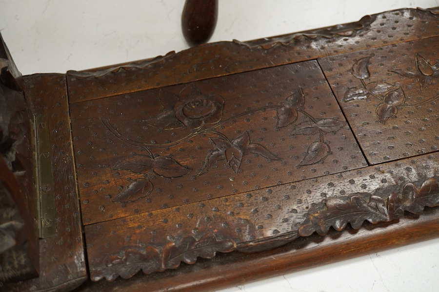 A Black Forest carved book-rack and a commemorative carved oak stool, for the Winchester college emblem, stool 39cm high